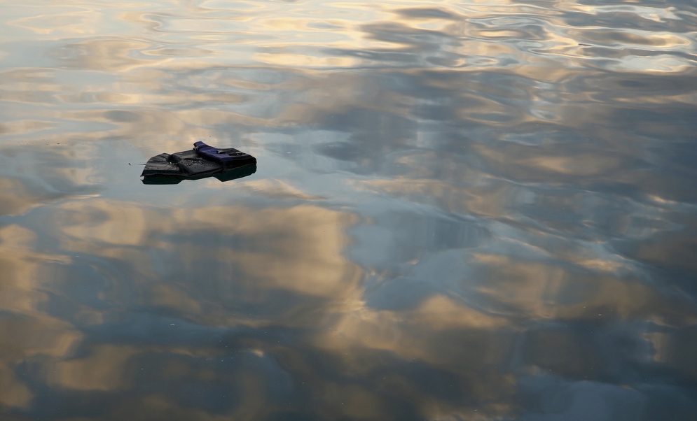 A lifejacket floats on the surface of the water at the port of Mytilene on the Greek island of Lesbos